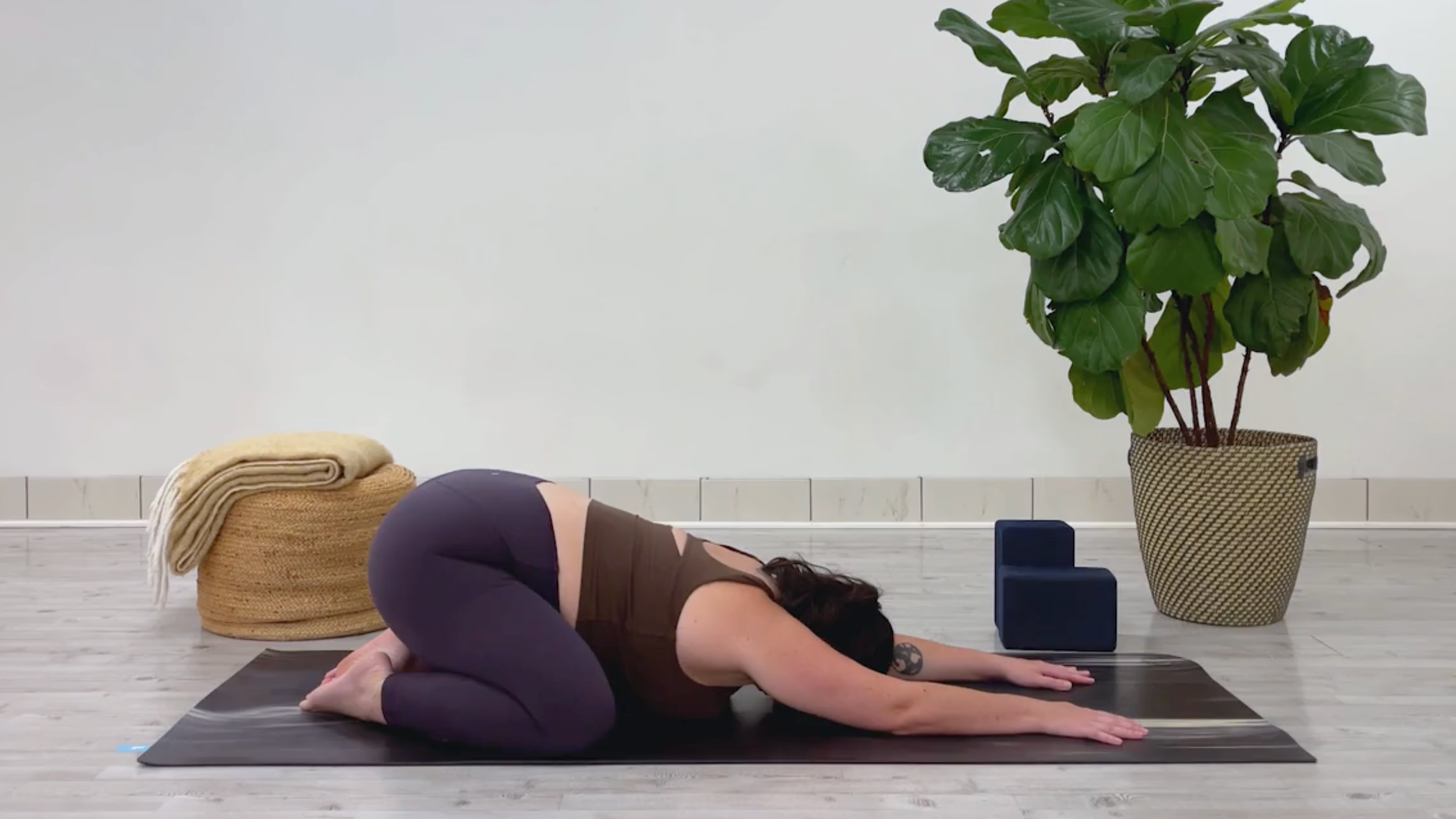 Yoga teacher Taylor Lorenz in Child's Pose, part of her 10-minute cool down yoga routine